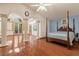 Spacious bedroom features a four-poster bed, hardwood floors, and an abundance of natural light at 2112 Preakness Pass, Las Vegas, NV 89117