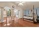 Stylish bedroom with hardwood floors, decorative columns, and access to a private outdoor space at 2112 Preakness Pass, Las Vegas, NV 89117