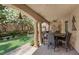 Covered patio with column supports featuring a dining table and view of the well-maintained backyard at 2112 Preakness Pass, Las Vegas, NV 89117