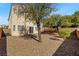Fully fenced backyard with desert landscaping and a sliding glass door at 2333 Silver Crew Pass, Henderson, NV 89052