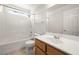Bright bathroom features a tub-shower combination and wood-trimmed vanity at 2333 Silver Crew Pass, Henderson, NV 89052