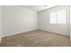 An empty bedroom features neutral carpet and a window with blinds at 2333 Silver Crew Pass, Henderson, NV 89052