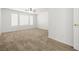 Bright bedroom featuring a ceiling fan, carpeted floors, and multiple windows for natural light at 2333 Silver Crew Pass, Henderson, NV 89052