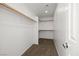 Walk-in closet featuring carpeted flooring, shelving and hanging rods for clothes storage at 2333 Silver Crew Pass, Henderson, NV 89052