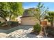Inviting two-story home featuring a two-car garage, complemented by mature trees and lush landscaping at 2333 Silver Crew Pass, Henderson, NV 89052