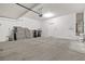An empty two-car garage offers ample storage with a door to the backyard at 2333 Silver Crew Pass, Henderson, NV 89052