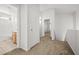 Upstairs hallway featuring carpet, white doors, and a view into the bathroom at 2333 Silver Crew Pass, Henderson, NV 89052