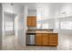 Bright kitchen featuring wood cabinetry, tile floors, stainless steel dishwasher, and granite countertops at 2333 Silver Crew Pass, Henderson, NV 89052