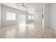 Spacious living room boasts tile flooring, plentiful natural light, and contemporary ceiling fan at 2333 Silver Crew Pass, Henderson, NV 89052