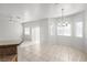 Bright living room featuring tile floors, neutral walls, and a stylish chandelier at 2333 Silver Crew Pass, Henderson, NV 89052