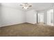 Spacious bedroom with carpeting, ceiling fan, and adjacent en-suite bathroom at 2333 Silver Crew Pass, Henderson, NV 89052