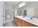 Spacious bathroom features dual sinks, a vanity, a large mirror, and a walk-in shower at 2343 Galilean Moon St, Henderson, NV 89044