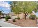 Single-story home boasting a two-car garage, desert landscaping and attractive curb appeal at 2343 Galilean Moon St, Henderson, NV 89044