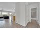 Bright and airy hallway leading to the living area and a bathroom, showcasing neutral tile flooring and fresh paint at 2343 Galilean Moon St, Henderson, NV 89044