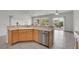 Bright kitchen featuring a breakfast bar, stainless steel appliances, and an adjacent dining area with sliding glass doors at 2343 Galilean Moon St, Henderson, NV 89044