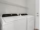 Laundry room featuring a Whirlpool washer and dryer, a door and wire shelving at 2343 Galilean Moon St, Henderson, NV 89044