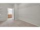 Bright, carpeted walk-in closet boasts plenty of storage space with white wire shelving and a bathroom at 2343 Galilean Moon St, Henderson, NV 89044