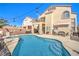 Beautiful backyard featuring a swimming pool, spa, and a cozy seating area at 2496 Citrus Garden Cir, Henderson, NV 89052