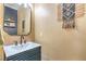 Stylish half bathroom featuring a modern sink and decorative wall accents at 2496 Citrus Garden Cir, Henderson, NV 89052