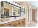 Bathroom featuring a large mirror, double vanity, and glass-enclosed shower at 2496 Citrus Garden Cir, Henderson, NV 89052
