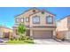 Inviting two-story home features a neutral color scheme, tile roof, and low-maintenance landscaping at 2496 Citrus Garden Cir, Henderson, NV 89052