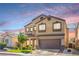 Inviting two-story home features a neutral color scheme, tile roof, and low-maintenance landscaping at 2496 Citrus Garden Cir, Henderson, NV 89052