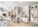 Open concept kitchen with tile floors, white cabinets, and stainless steel appliances at 2496 Citrus Garden Cir, Henderson, NV 89052