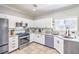 Bright kitchen features stainless steel appliances, white cabinetry, and granite countertops at 2496 Citrus Garden Cir, Henderson, NV 89052