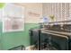 Laundry area with modern machines, stylish wallpaper, and natural light at 2496 Citrus Garden Cir, Henderson, NV 89052