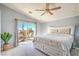 Bright main bedroom with a ceiling fan and sliding glass doors to a patio at 2496 Citrus Garden Cir, Henderson, NV 89052