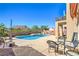 Private backyard with refreshing swimming pool, jacuzzi, and comfortable seating areas for outdoor relaxation at 2496 Citrus Garden Cir, Henderson, NV 89052