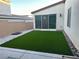 The home includes a beautifully landscaped backyard with artificial grass and easy access from the sliding glass door at 2726 Marchetti Pl, Henderson, NV 89044