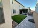 A cozy backyard featuring artificial grass, rock landscaping, and a covered patio great for outdoor entertaining at 2726 Marchetti Pl, Henderson, NV 89044