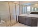 Modern bathroom with dual sink vanity, frameless shower, and white tile at 2726 Marchetti Pl, Henderson, NV 89044