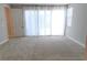 Bright bedroom featuring neutral walls, plush carpet, and sheer curtains over a large window at 2726 Marchetti Pl, Henderson, NV 89044