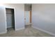 Neutral bedroom with open closet space and access to other rooms, featuring neutral walls and carpeting at 2726 Marchetti Pl, Henderson, NV 89044