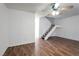 Bright living room featuring laminate floors, ceiling fan, and staircase at 3164 Richford Pl, Las Vegas, NV 89102