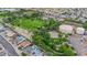 An aerial view of a lush park, tennis courts, and a water tank near residential houses at 334 Laurel Peak Dr, Henderson, NV 89015