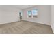 Spacious bedroom with large windows offering natural light, and neutral carpet flooring at 334 Laurel Peak Dr, Henderson, NV 89015