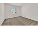 Simple bedroom with neutral carpet, window, and white walls at 334 Laurel Peak Dr, Henderson, NV 89015