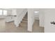 Inviting entryway with modern staircase, open floor plan, and lots of natural light at 334 Laurel Peak Dr, Henderson, NV 89015