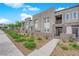 Modern townhome showcasing a landscaped front yard and neutral stucco facade with stone accents at 334 Laurel Peak Dr, Henderson, NV 89015