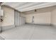 Spacious garage with epoxy flooring and built-in storage cabinets for organized parking and storage at 334 Laurel Peak Dr, Henderson, NV 89015