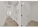 Hallway with white cabinets and doors, complemented by neutral carpeting at 334 Laurel Peak Dr, Henderson, NV 89015