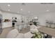 Open-concept living space features a modern kitchen, dining area, and stylish seating arrangements at 334 Laurel Peak Dr, Henderson, NV 89015