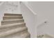 Carpeted staircase leads to the upper level, complemented by white walls and a simple handrail at 334 Laurel Peak Dr, Henderson, NV 89015