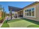 Lush backyard with well-kept lawn, a pergola-covered patio, and an outdoor dining and lounge area at 3434 Boleo Ct, Las Vegas, NV 89141
