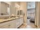 Bright bathroom with double sinks, granite counters, and a view into the main bedroom at 3434 Boleo Ct, Las Vegas, NV 89141