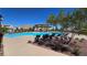 Beautiful community pool with lounge chairs, shade structures, and landscaping, perfect for relaxation at 3434 Boleo Ct, Las Vegas, NV 89141