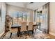 Bright dining room features a modern chandelier, plantation shutters, and a glass door to the backyard at 3434 Boleo Ct, Las Vegas, NV 89141
